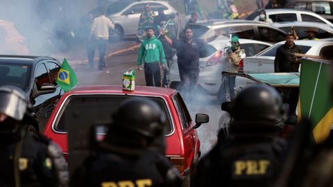 Military police attempt to clear a roadblock in Novo Hamburgo, southern Brazil, on Tuesday.