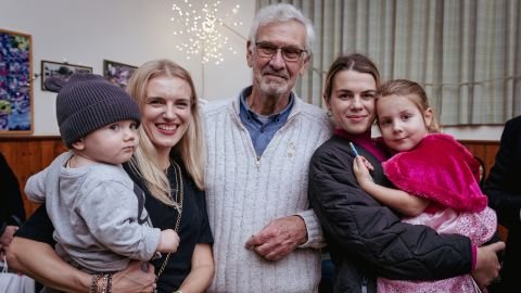 Robert Aitkin, center, and his wife welcomed the Kuzmenko family into their home.