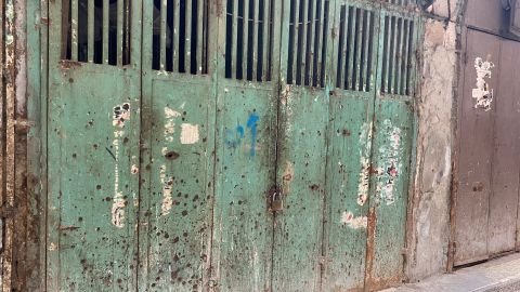 Bullet holes in a door testify to the violence of the previous day.