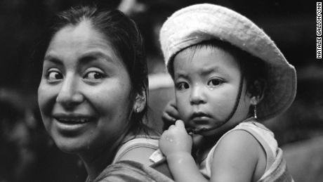 A Peruvian woman and baby pause for a moment on the trek. &quot;It has been calm but tiring. We had food but we don&#39;t anymore,&quot; she said.