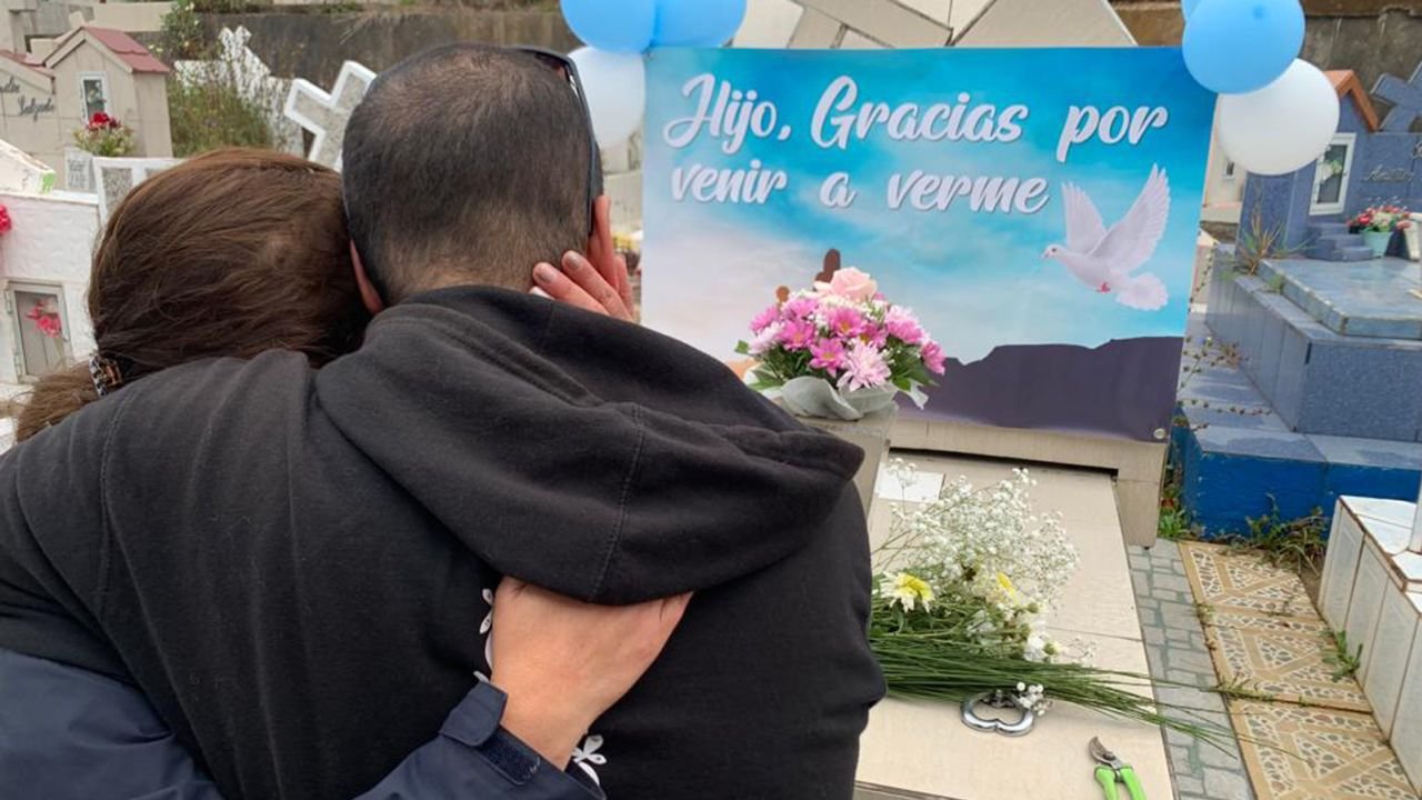 Scott and his half-sister, Jenny Escalona, at their mother's grave in Chile.