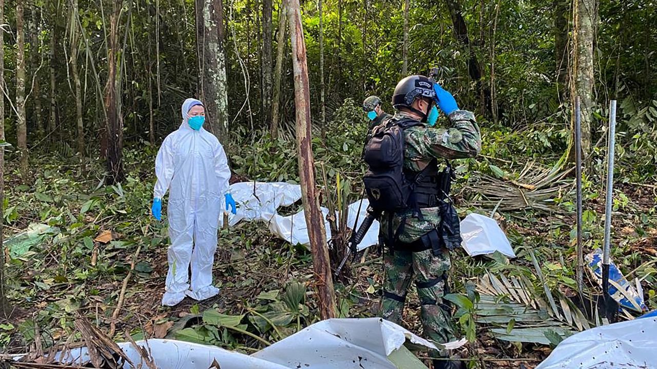Soldiers stand next to the wreckage of a plane during the search for child survivors on May 19, 2023.