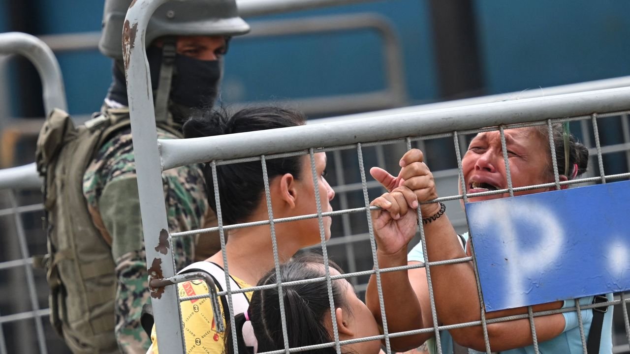 A woman cries outside outside the Guayas 1 prison a day after a fight between rival gangs left six inmates dead in Guayaquil, Ecuador, on July 24, 2023.