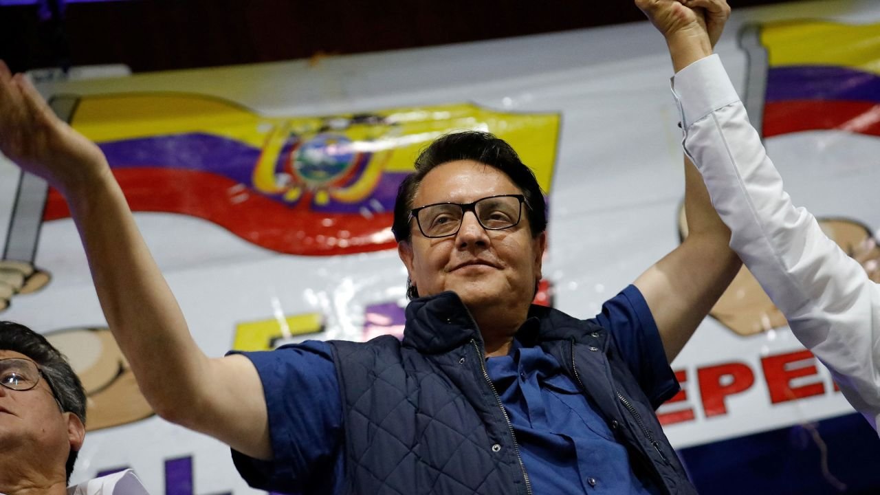 Ecuadorean presidential candidate Fernando Villavicencio waves an Ecuadorian flag as he attends a rally in Quito on August 9.