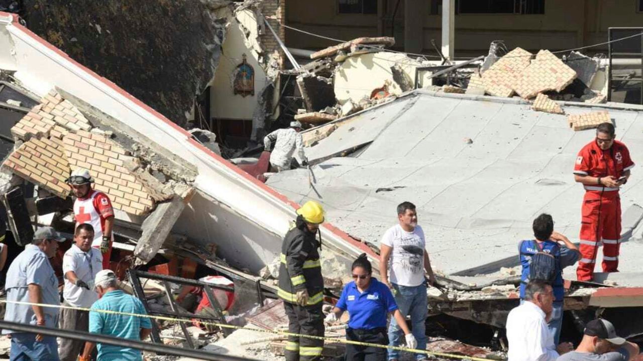Rescue workers search in the debris for dozens of worshipers missing following the disaster.